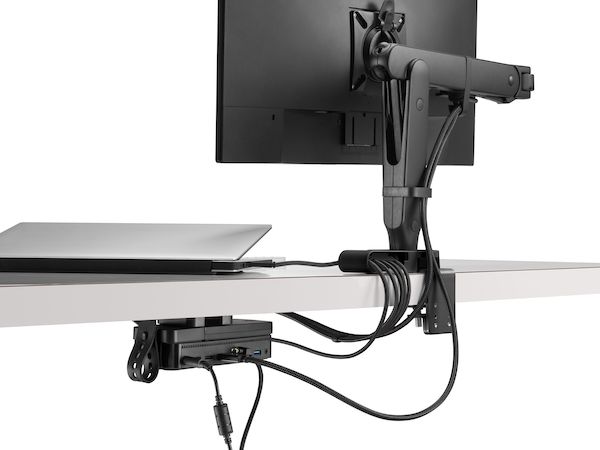 Back view of a monitor screen with power and data cables routed from the connected monitor arm and through an Ondo Connectivity Module and Loop Micro under a desk.