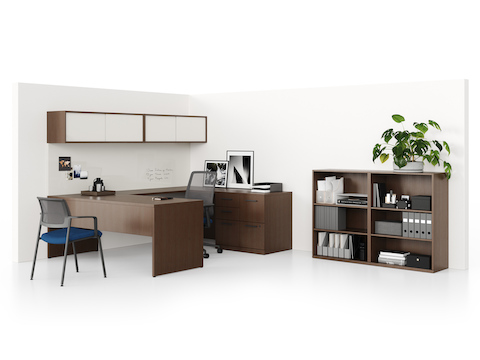 A Canvas Private Office with a U-shaped workstation and freestanding bookcase in a dark wood finish, supported by Verus office and side chairs.