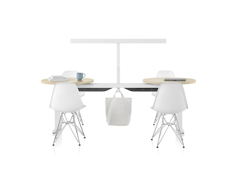 White and light brown Canvas Vista cafe setting with white t-shaped light and white chairs.