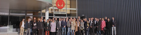 More than three dozen dealers gather outside a Herman Miller facility.