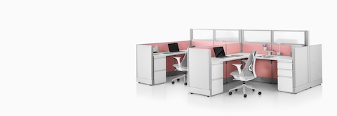 Gray Sayl Chairs at Action Office workstations with pink fabric panels and glass dividing walls.