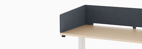 Open, navy metal storage attached to laminate surface of desk with navy fabric wrapped screen.