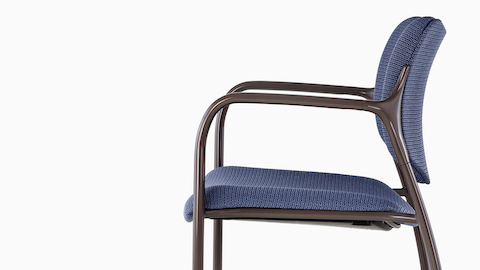 Blue Aside Chair with brown arms, viewed from the side.