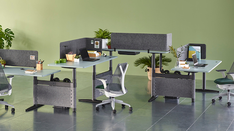Sayl office chairs complement a zigzag configuration of four height-adjustable Atlas Office Landscape desks with blue tops.