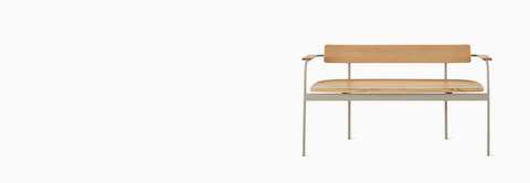 A Betwixt Bench with oak seat, backrest, and arms with a grey frame.