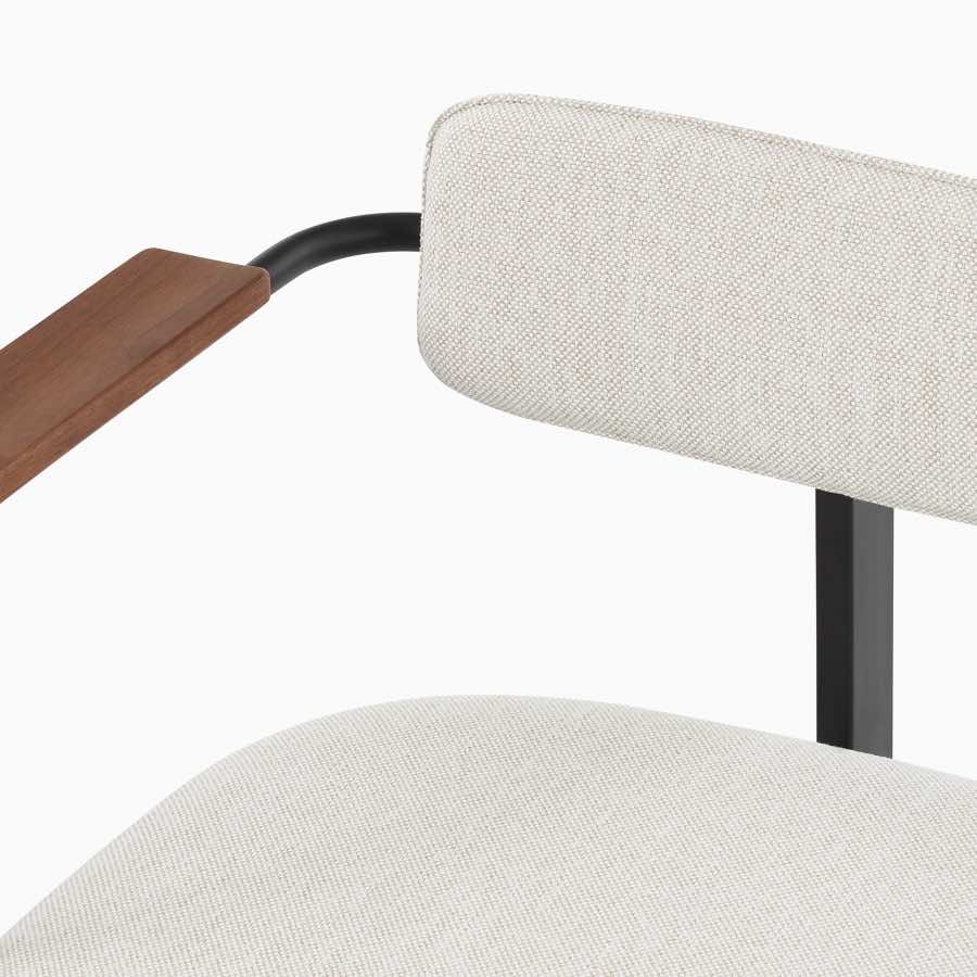 A Betwixt Bench with fabric seat, backrest, walnut arms, and a black frame.