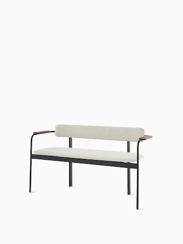 A Betwixt Bench with grey fabric seat and backrest, with walnut arms and a black frame.