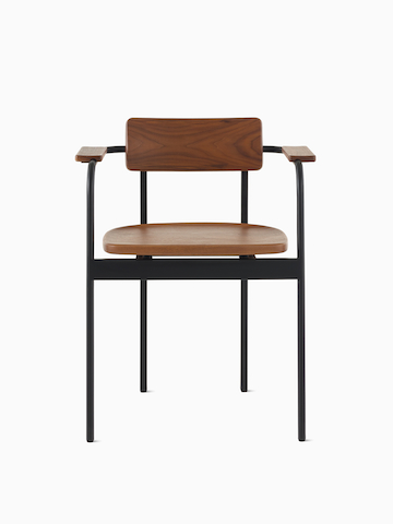 A Betwixt Chair with a walnut backrest, seat, and arms with a black frame. 
