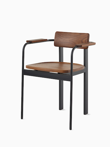 A Betwixt Chair with a walnut backrest, seat, and arms with a black frame. 