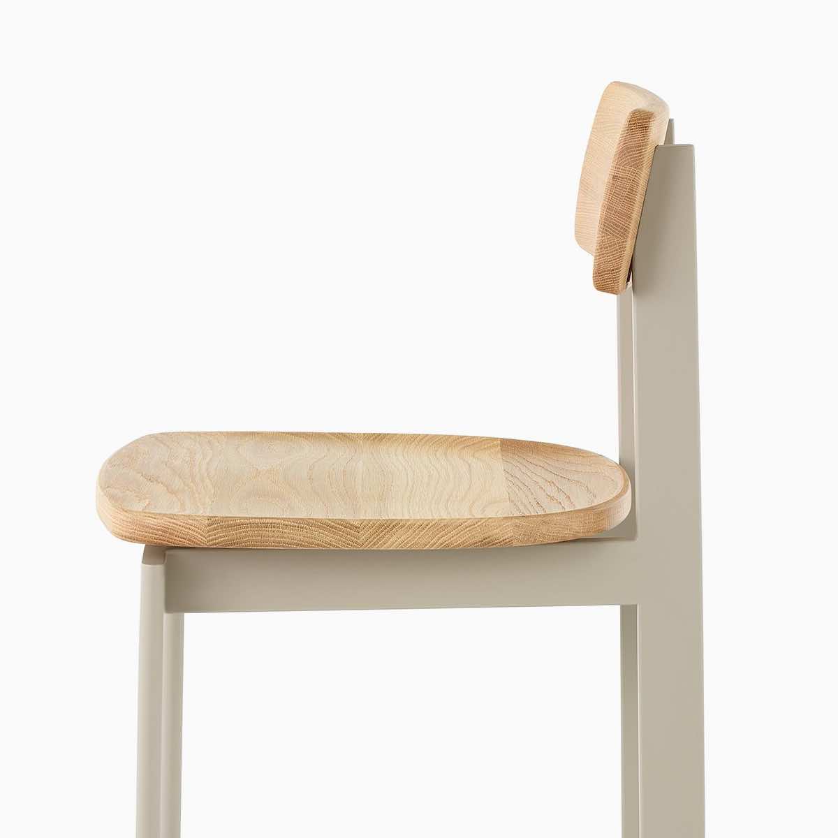 A bar height Betwixt Stool with oak oak seat and backrest with a grey frame.
