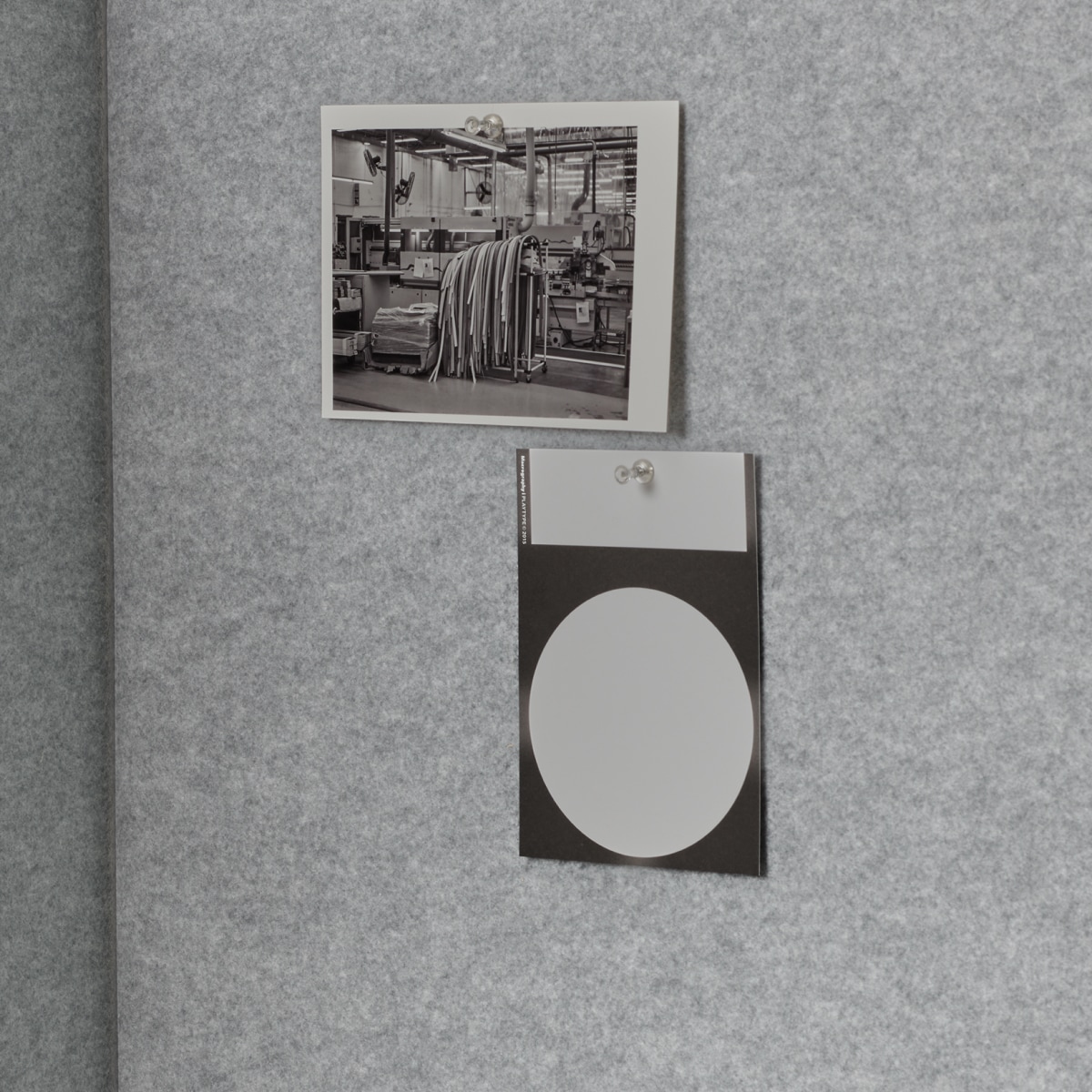 Detail of two grey tackboards on interior panels of Bound Sit-Stand Booth.