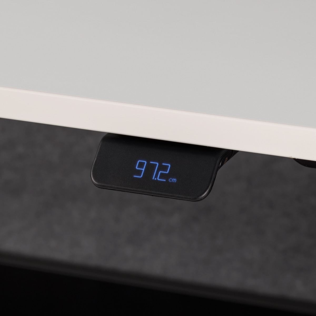 Height adjustable digital high performance handset on white worksurface.