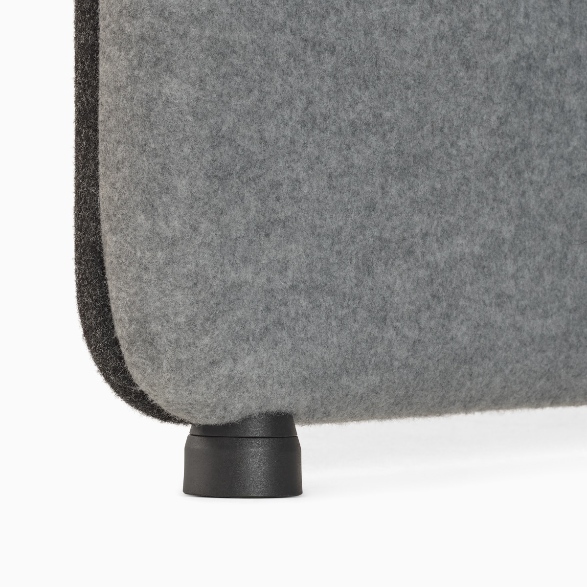 Detail of black foot attached to light grey gallery panel on Bound Sit-Stand Booth