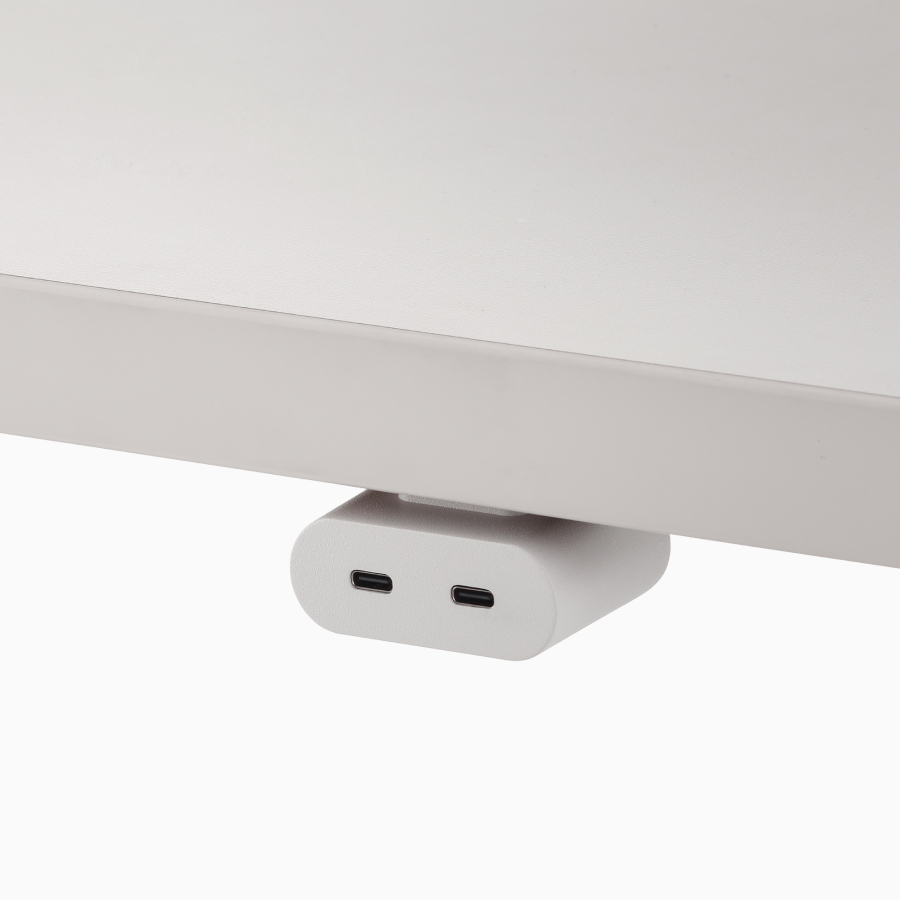 White USB-C power access module that is attached to a white surface.