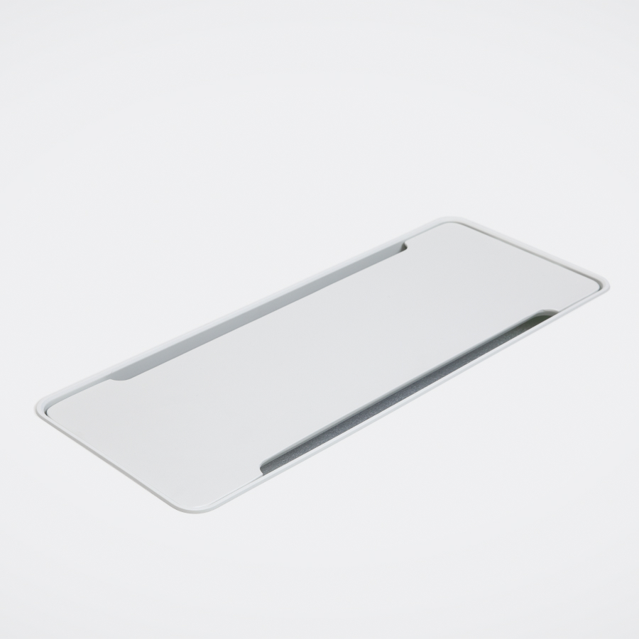Detailed view of a large, closed access flap in a white table.