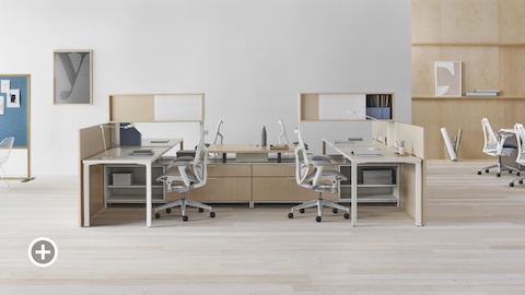 A Canvas Vista workstation with white Mirra 2 office chairs. Select to go to the Individual Workstations page within the Canvas Lookbook.