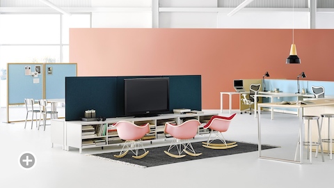 An office setting with Canvas Dock, Canvas Storage with blue screens, and pink Eames molded plastic rocking chairs. Select to go to the Impromptu Meeting Spaces page within the Canvas Lookbook.   
