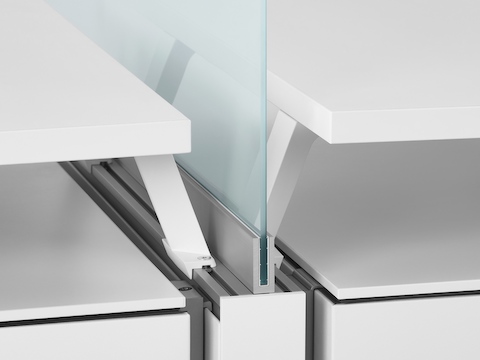 A close-up image of a glass screen boundary between two Canvas Dock workstations. Select to go to the Canvas Dock specs page.