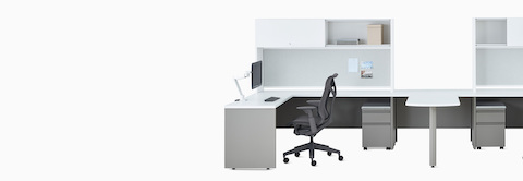 Two white and gray Canvas Metal Desks with upper storage, Concerto Monitor Arm, and dark gray Cosm Chair.