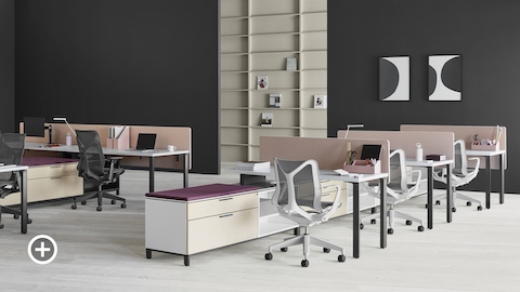 Two Canvas Storage workstations with pink screens, lower storage with purple cushion tops, and Cosm office chairs. Select to go to the Shared Workspaces page within the Canvas Lookbook.