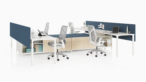 A Canvas Storage workstation with white surfaces, blue screens, and light grey Cosm office chairs.