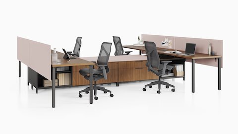 A Canvas Storage workstation in dark wood with pink screens and dark grey Cosm office chairs.