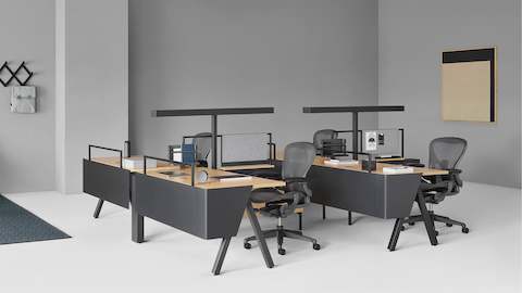 Canvas Vista workstations with black Aeron office chairs and a Canvas Vista collaborative space in the background.