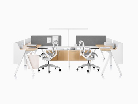 Canvas Vista workstations in light wood and white with modesty screens, t-shaped light, and grey Cosm office chairs.
