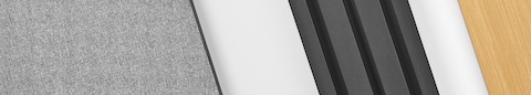 A close-up image of different Canvas Vista materials such as grey fabric, black metal, and light wood.