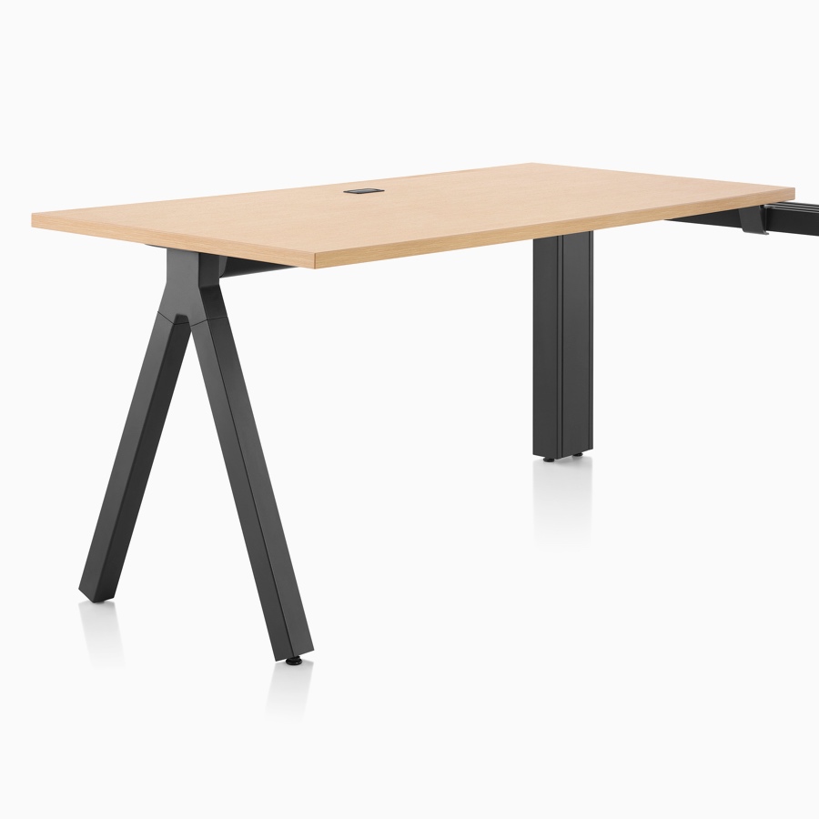A light wood Canvas Vista fixed-height table with black a-shaped leg.