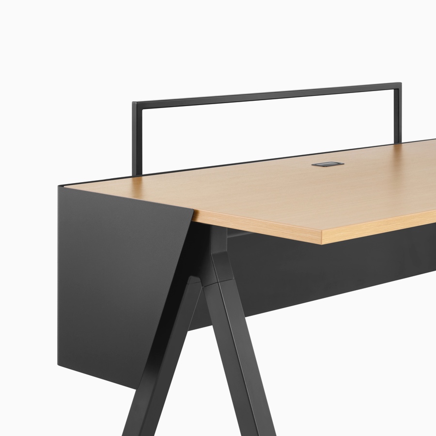 A black modesty screen and open-frame screen with light wood and black Canvas Vista fixed-height table.