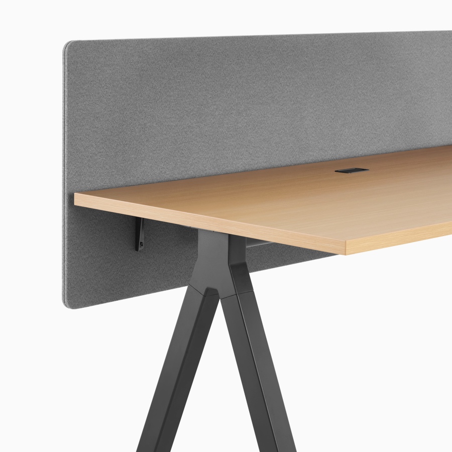 A grey fabric screen with light wood and black Canvas Vista fixed-height table.