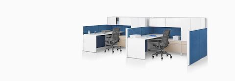 A Canvas Wall workstation with blue panels, white overhead storage, and dark grey Cosm office chairs.