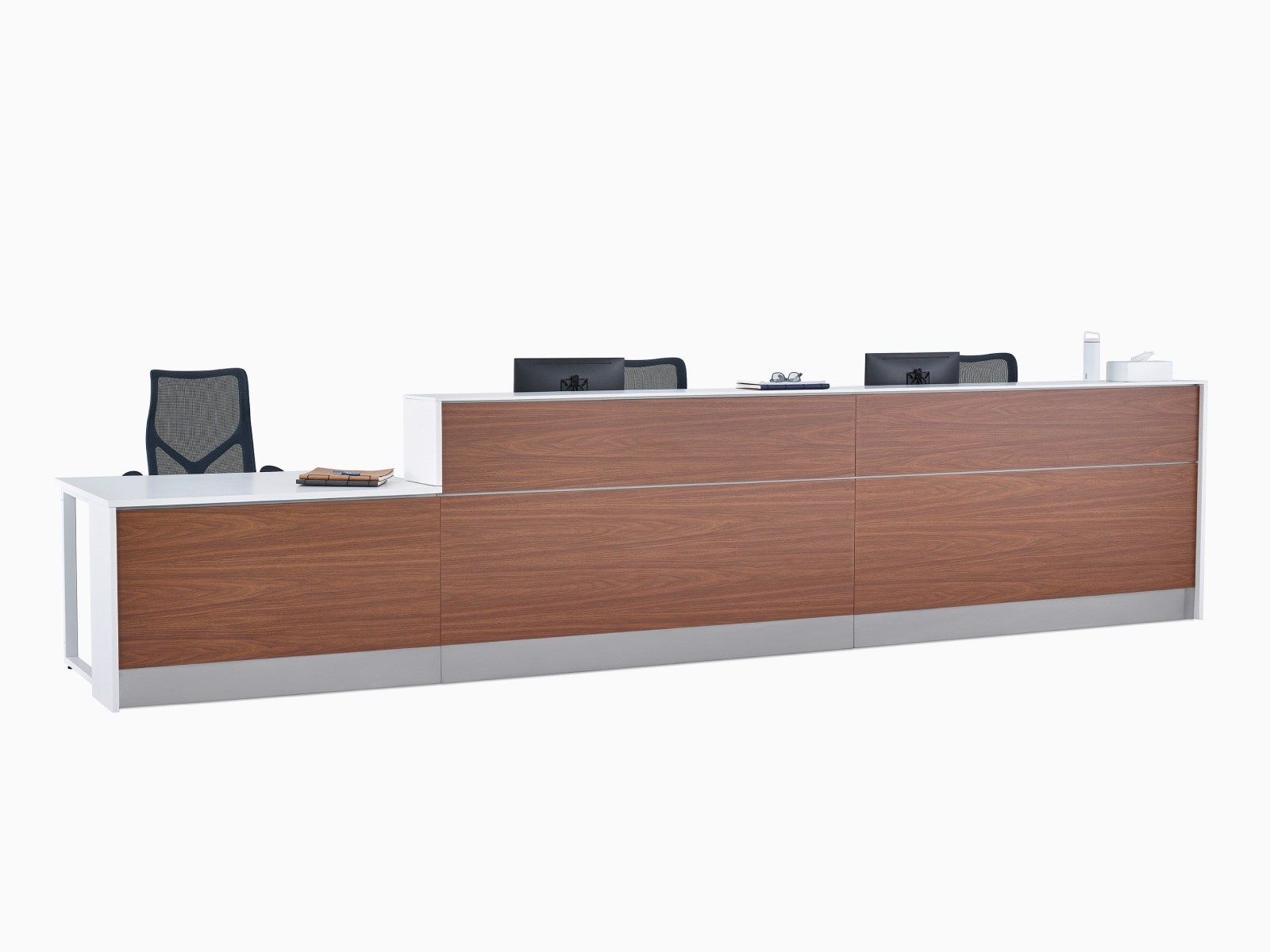 Prefab Commend Nurses Station for three with white Corian tops, dark blue Cosm Chairs, walnut woodgrain laminate front, and stainless steel toe kicks.