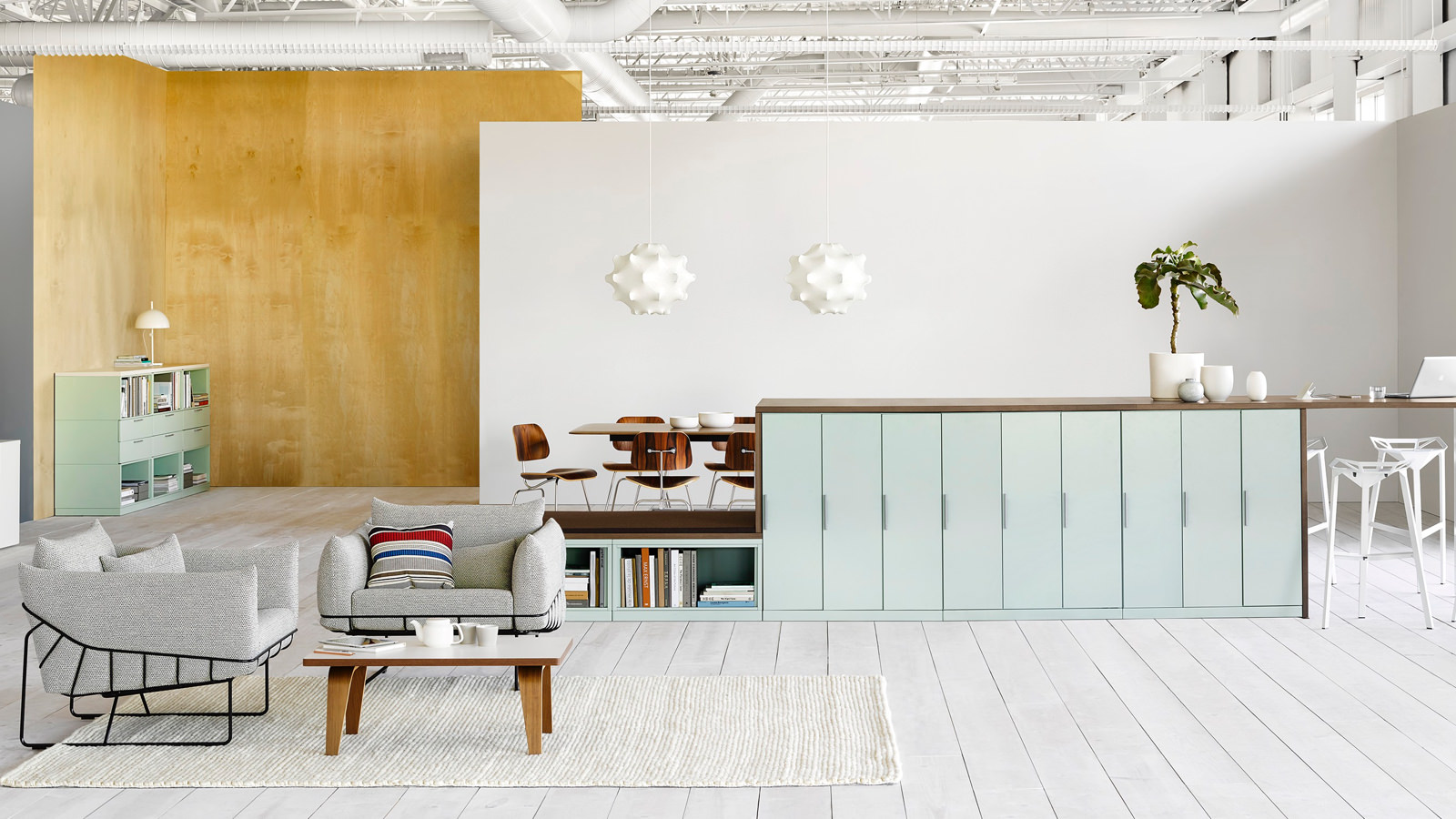 A series of light blue Meridian storage lockers divide space and provide work surface in an open collaboration area.
