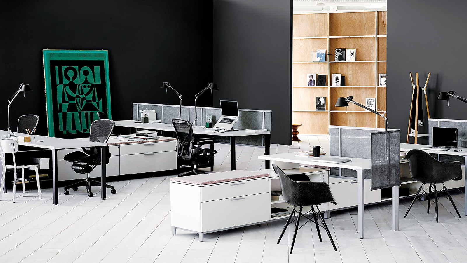 White Canvas Storage units delineate space and provide guest seating in an open office.