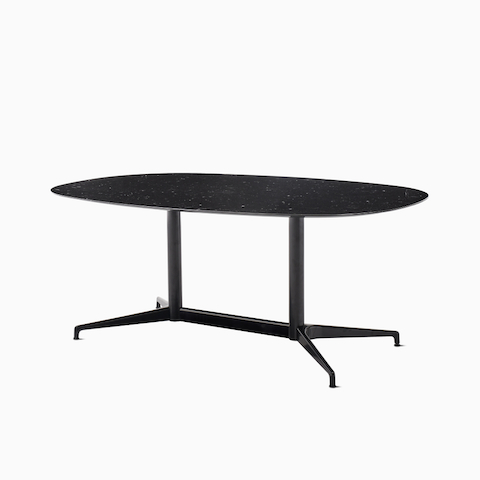 An oval Civic Table with a black marble top and black understructure, viewed at an angle.