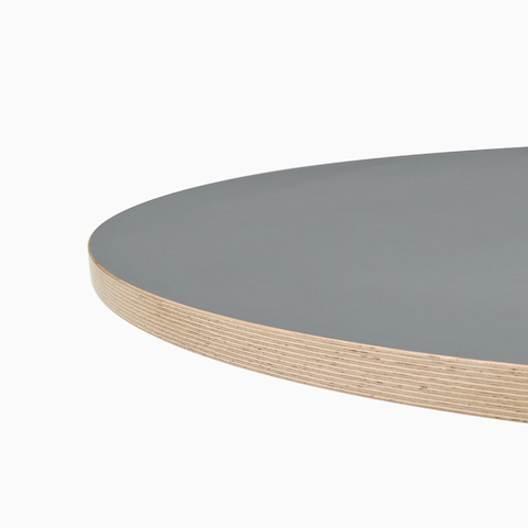 A close up view of a gray Civic Table top with a wooden square edge.