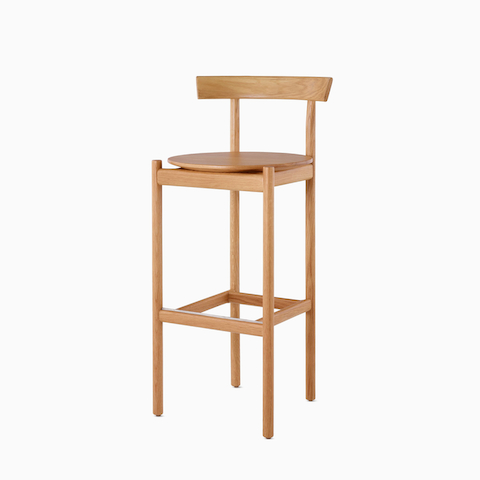An oak bar-height Comma Stool, viewed from the front at an angle.