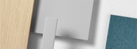 A close-up of various materials for Commend Nurses Station including woodgrain laminate, brushed stainless steel, and blue textile.
