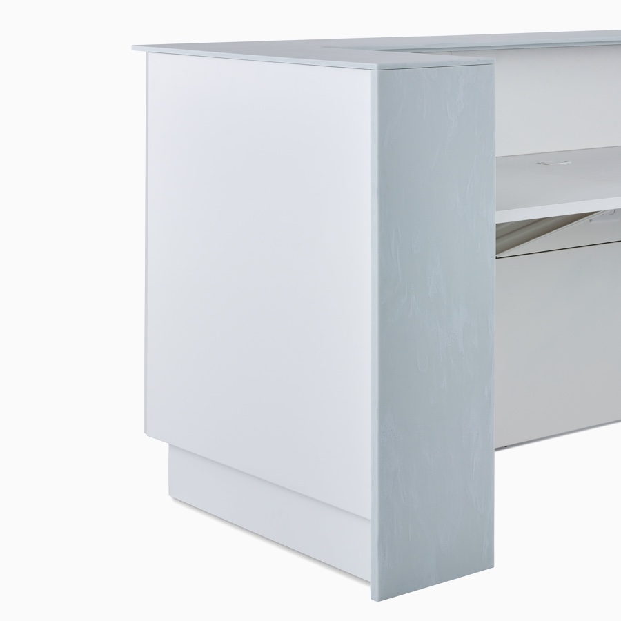 A close-up view of a Commend Nurses Station's corner with off-white Corian tops.