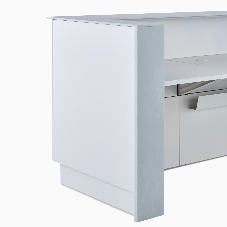 A close-up view of a Commend Nurses Station's corner with off-white Corian tops.