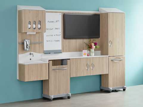 A light wood finish Compass System footwall in patient room setting.