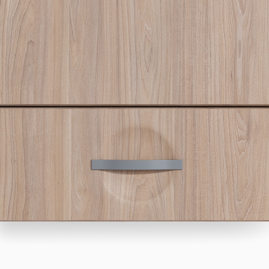 A Compass casework storage drawer in an elm wood finish and a flex pull in a gray finish.