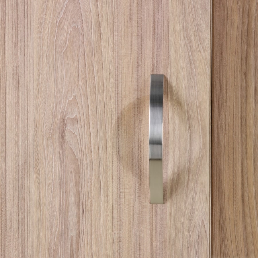 A close-up view of a Compass System wardrobe cabinet in a medium wood finish.