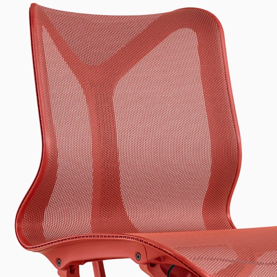 A low-back Cosm Chair with no arms and a Canyon red frame and suspension material.