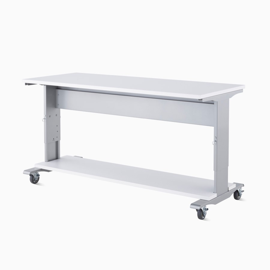 Detail of a Co/Struc System work process table in silver finish with a white top surface and a bottom reagent shelf in white.