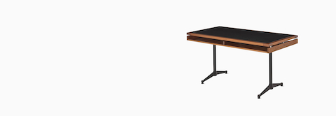 An Eames 2500 Series Executive Desk in walnut with black leather inlay.