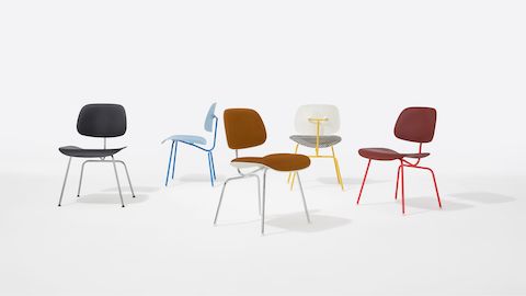 A group of Eames Molded Plastic Dining Chair EC-127 in mutliple upholstered and non-upholstered colors with metal frames.