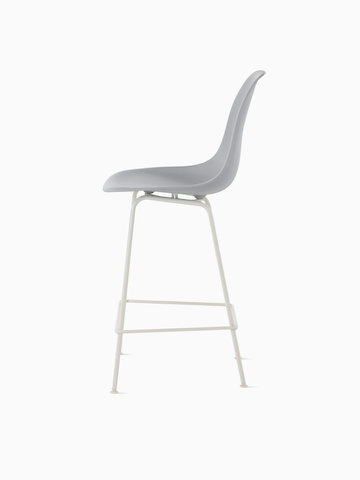 Black Eames Molded Plastic Stool with dark blue upholstery, viewed from a 45-degree angle. 